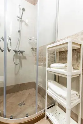 a bathroom with a shower with a glass shower stall at Bissera premium apartments in Sofia