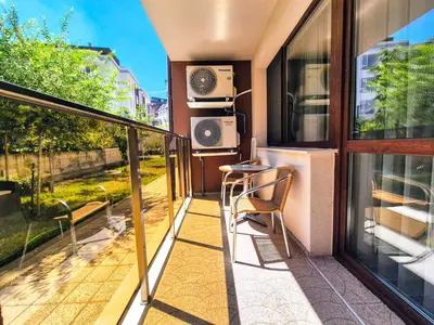 a balcony with a table and chairs on it at Bissera premium apartments in Sofia