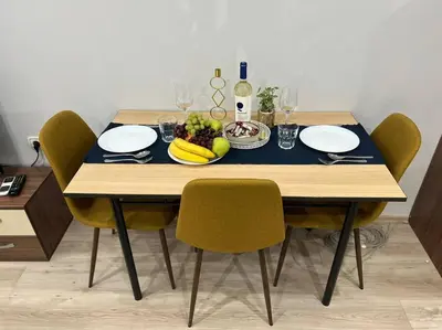 a dining table with a plate of fruit and wine glasses at Nomadic Travelers Apartment in Sofia
