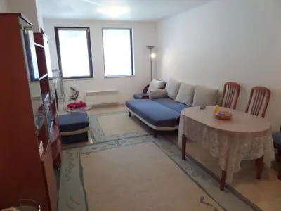 a living room with a couch and a table at Apartment in Complex Monastery 1 in Pamporovo