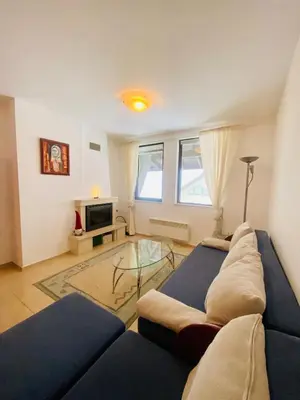 a living room with a couch and a glass table at Apartment in Complex Monastery 1 in Pamporovo