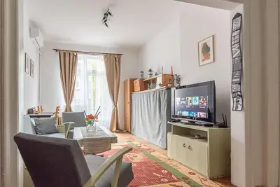 a living room with a couch and a television at Centrally Located Vintage Flat in Sofia