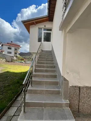 a set of stairs leading to a house at Къща за гости Горски рай in Smilyan