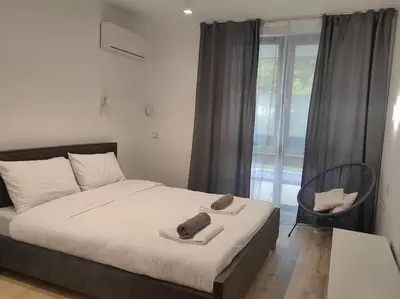 a bedroom with a bed with two towels on it at The Courtyard 2Bdrm Apartment in Sofia