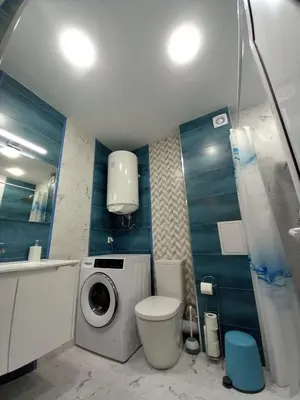 a bathroom with a washing machine and a toilet at Аpartment Van Gogh in Hisarya