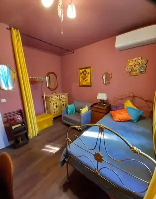 a bedroom with a bed and a couch at Аpartment Van Gogh in Hisarya