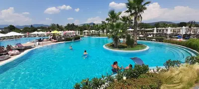 a swimming pool at a resort with people in it at Аpartment Van Gogh in Hisarya