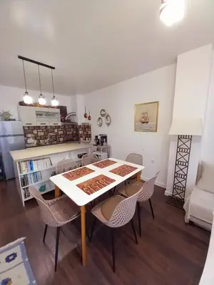 a kitchen and dining room with a table and chairs at Аpartment Van Gogh in Hisarya