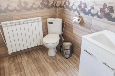 a bathroom with a toilet and a sink at GreenBoxApartment in Kyustendil