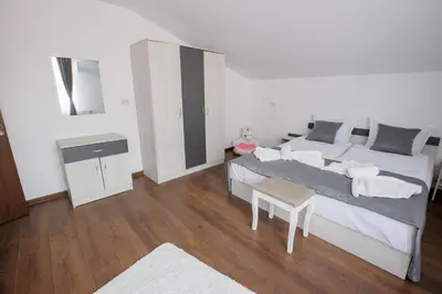 a bedroom with a large bed and a table at GreenBoxApartment in Kyustendil