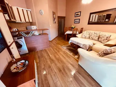 a living room with a couch and a table at Marina Apartment - Mountain View in Bansko