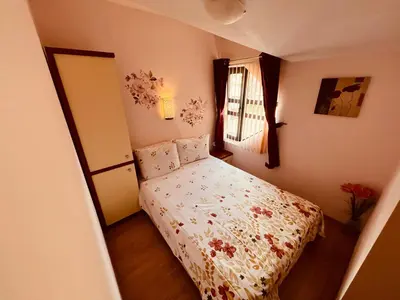 a small bedroom with a bed and a window at Marina Apartment - Mountain View in Bansko