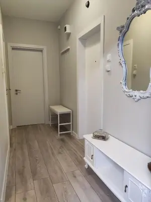 a dressing room with a mirror and a table at Maya's Airport Apartment in Sofia
