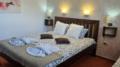a bedroom with a bed with towels on it at Bansko Prespa Ski Penthouse in Bansko