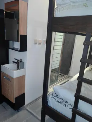 a bathroom with a sink and a bunk bed at Bansko Prespa Ski Penthouse in Bansko