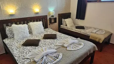 two beds in a room with towels on them at Bansko Prespa Ski Penthouse in Bansko