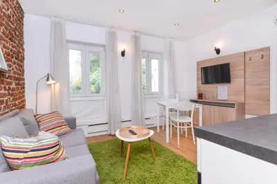 a living room with a couch and a table at Antim Boutique Apartments in Sofia