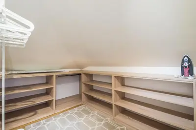 a walk in closet with wooden shelves at Antim Boutique Apartments in Sofia