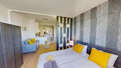 a bedroom with a bed and a living room at Modern City Stay apartment 4 min walk from Alexander Nevski in Sofia