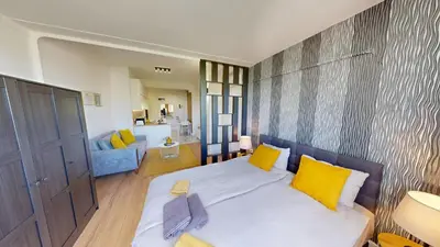 a bedroom with a large bed with yellow pillows at Modern City Stay apartment 4 min walk from Alexander Nevski in Sofia
