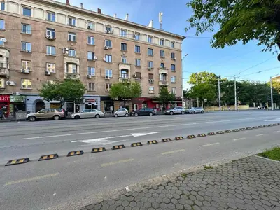 an empty street with cars parked in front of a building at Modern City Stay apartment 4 min walk from Alexander Nevski in Sofia