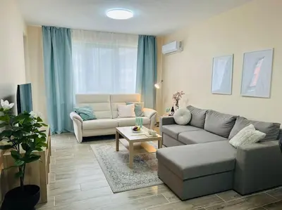 a living room with a couch and a table at Malinova Stylish Apartment in Sofia