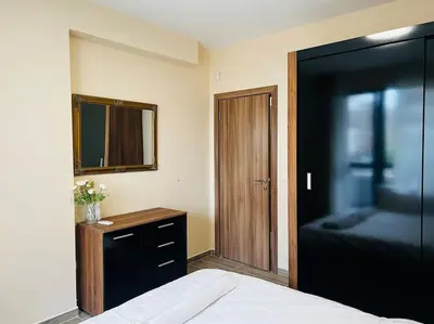 a bedroom with a bed and a mirror and a dresser at Malinova Stylish Apartment in Sofia