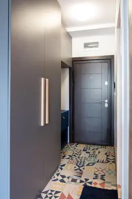 a hallway with a door and a tile floor at Artistic Flat in City Center for Business&Pleasure Trips in Sofia