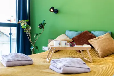 a bed with a wooden tray on top of it at Artistic Flat in City Center for Business&Pleasure Trips in Sofia