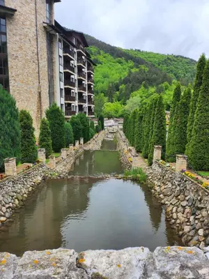 a body of water in front of a building at Студио Бети Балнео Спа Хотел Свети Спас in Velingrad