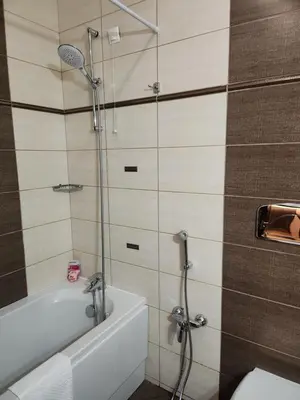 a bathroom with a shower and a tub and a toilet at Студио Бети Балнео Спа Хотел Свети Спас in Velingrad
