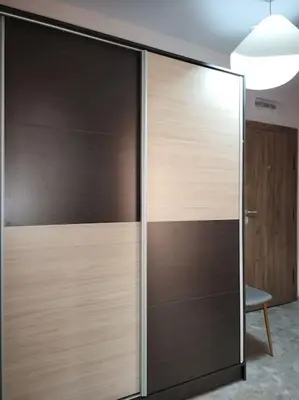 a sliding glass door in a room with a chair at Stylish apartment near City, entire flat, 1 bedroom, 1 large bed in living room in Plovdiv