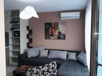 a living room with a couch and a table at Stylish apartment near City, entire flat, 1 bedroom, 1 large bed in living room in Plovdiv