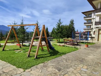 a park with a swing set and a playground at Panorama Stoykite Eurydice in Stoykite