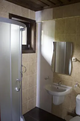 a bathroom with a sink and a toilet at Delchevata Kushta V Leshten in Leshten