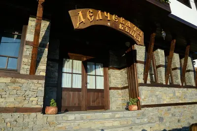 a entrance to a building with a wooden door at Delchevata Kushta V Leshten in Leshten