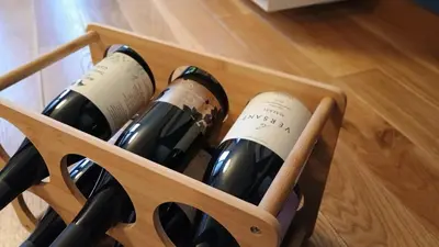 a wooden wine rack filled with bottles of wine at Modern Comfort near Airport, The Mall, TechPark by KeyBox in Sofia