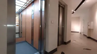 an empty hallway of an office building with a glass door at Modern Comfort near Airport, The Mall, TechPark by KeyBox in Sofia