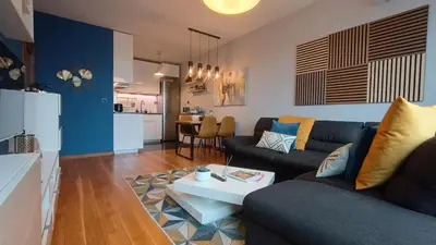 a living room with a couch and a table at Modern Comfort near Airport, The Mall, TechPark by KeyBox in Sofia