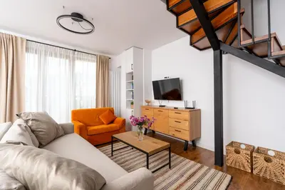 a living room with a couch and a chair at Apart house EMA 4 in Bansko