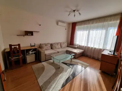 a living room with a couch and a glass table at Spacious 2 Bedroom Apartment in Sofia