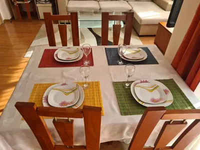 a table with plates and wine glasses on it at Spacious 2 Bedroom Apartment in Sofia