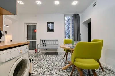 a kitchen and living room with a table and chairs at Apart Hotel Roma in Sofia