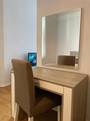 a desk with a chair and a mirror at The Central Post Apartments in Sofia