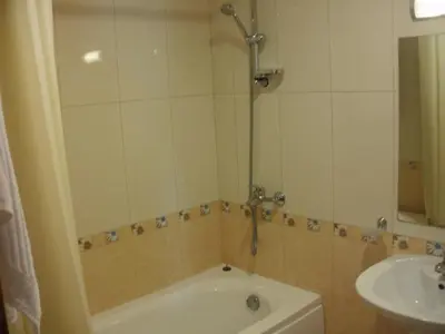 a bathroom with a bath tub and a sink at Deluxe Room in Stoykite in Pamporovo