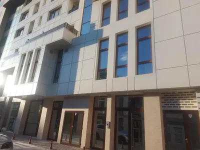 an external view of a building with glass doors at Апартамент за гости Асеновец in Asenovgrad