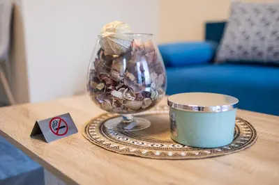 a vase with seashells and a candle on a table at Central & Quiet 2BR with Free Private Parking in Sofia