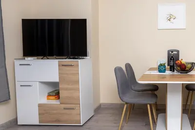 a living room with a tv on a white entertainment center at Central & Quiet 2BR with Free Private Parking in Sofia