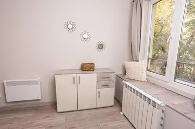 a white room with a radiator and a window at Modern 1BR Comfort in Oborishte with Private Parking in Sofia