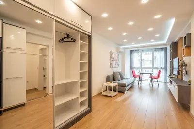 a room with a walk in closet and a dining room at Zenith Apartment in Sofia